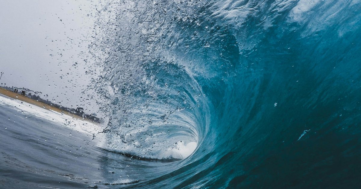 A large barrel wave breaking near the shore in Newport Beach, California